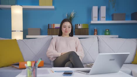 Asian-Young-Woman-Completes-Her-Work-In-Her-Home-Office-And-Relaxes.